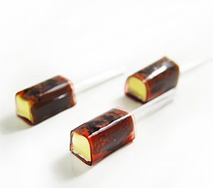 Brie Cheese with Black Truffle Pate wrapped with Red Wine Paper in skewer