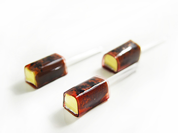 Brie Cheese with Black Truffle Pate wrapped with Red Wine Paper in skewer